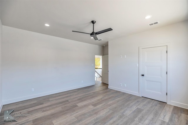 unfurnished bedroom with recessed lighting, wood finished floors, visible vents, and baseboards