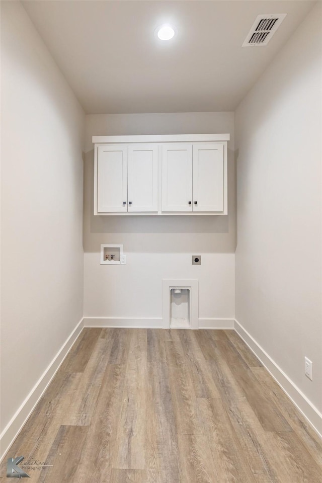 washroom with hookup for a washing machine, visible vents, baseboards, cabinet space, and electric dryer hookup