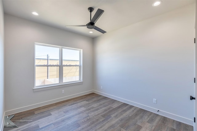 spare room with wood finished floors and baseboards