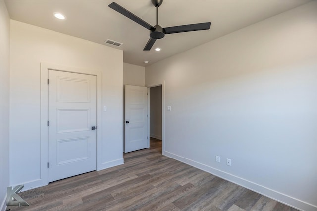 unfurnished bedroom with baseboards, visible vents, wood finished floors, and recessed lighting