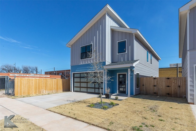 view of front of house featuring driveway, fence, and board and batten siding