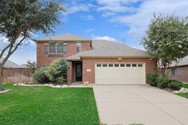 view of front facade with a front yard and a garage