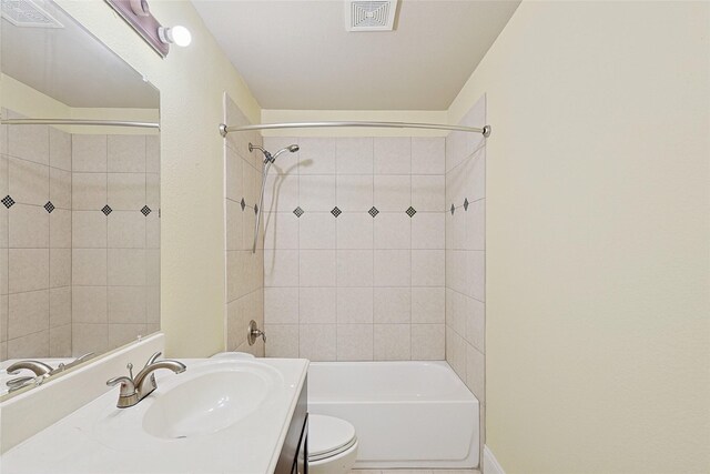 full bathroom with vanity, toilet, and tiled shower / bath