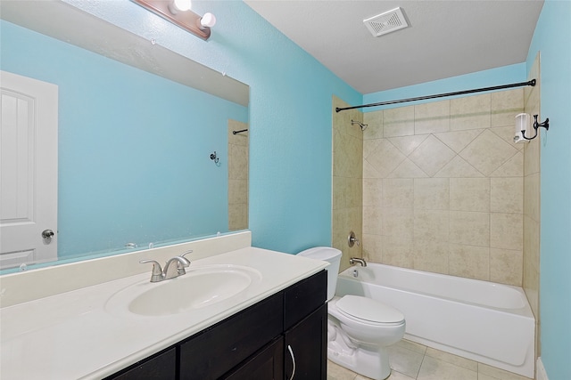 full bathroom with tile patterned flooring, vanity, tiled shower / bath combo, and toilet