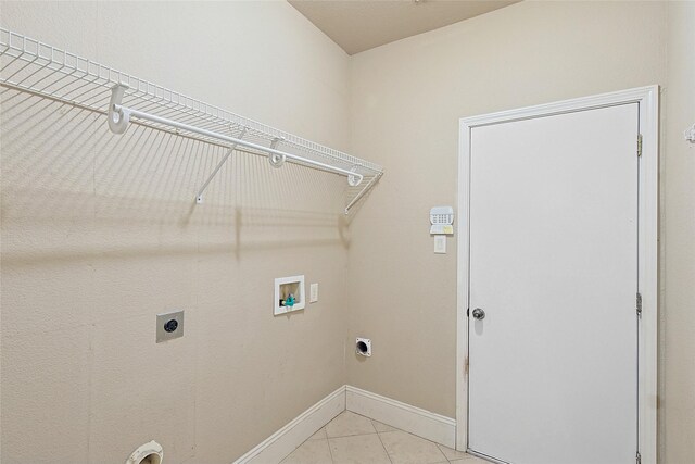 laundry area featuring hookup for an electric dryer, hookup for a washing machine, and light tile patterned floors