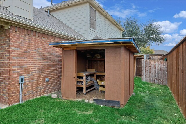 view of outbuilding featuring a lawn