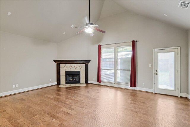 unfurnished living room with a fireplace, ceiling fan, light hardwood / wood-style flooring, and high vaulted ceiling