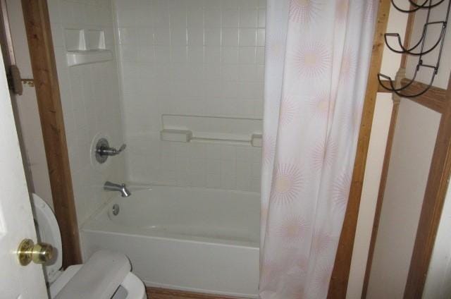 bathroom with shower / tub combo and toilet