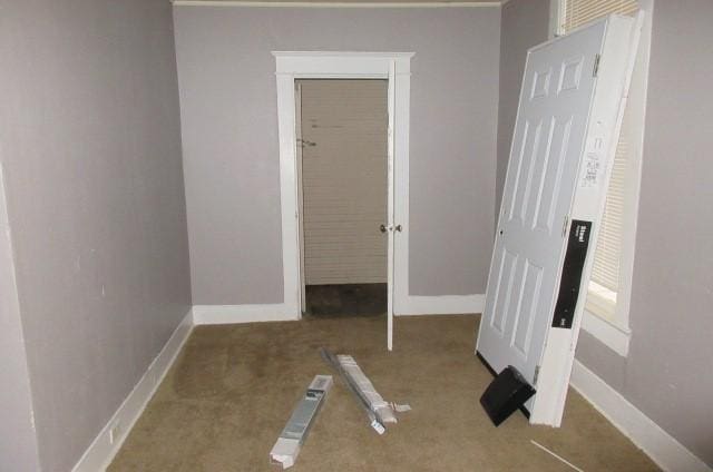 unfurnished bedroom with light colored carpet and a closet