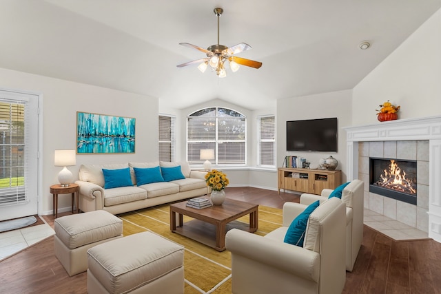 living room with a fireplace, vaulted ceiling, ceiling fan, and hardwood / wood-style flooring