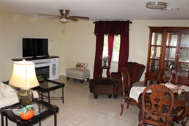 tiled living room featuring ceiling fan