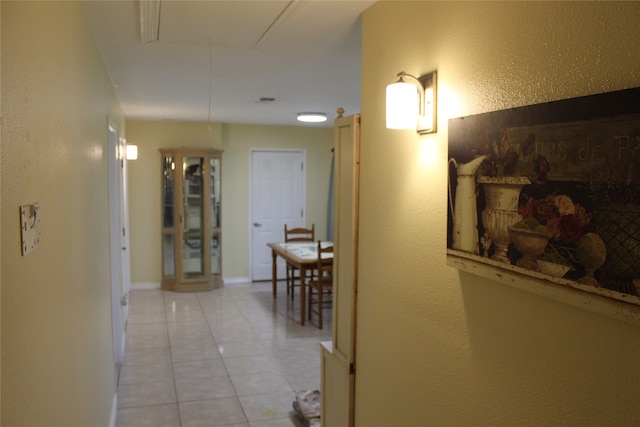 hall featuring light tile patterned flooring