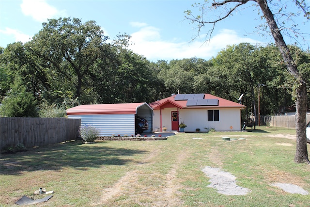 ranch-style house with solar panels and a front lawn