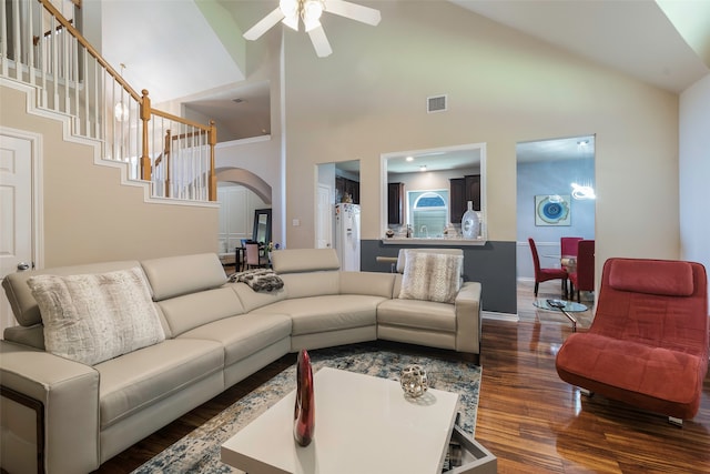 living room featuring high vaulted ceiling, ceiling fan, and dark wood-type flooring