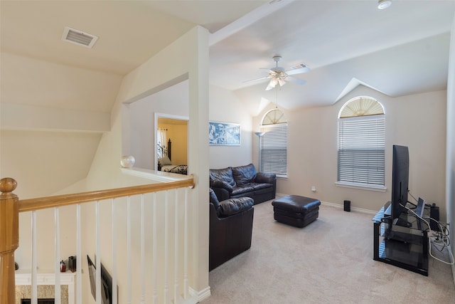 carpeted living room with ceiling fan and lofted ceiling