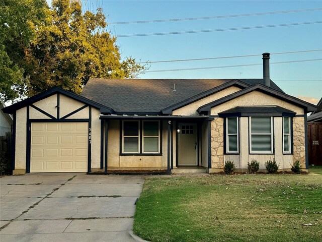 view of front of property with a front yard and a garage