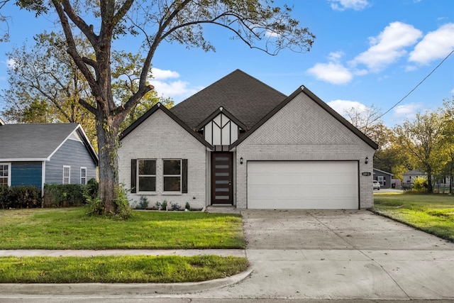 view of front of property with a front yard and a garage