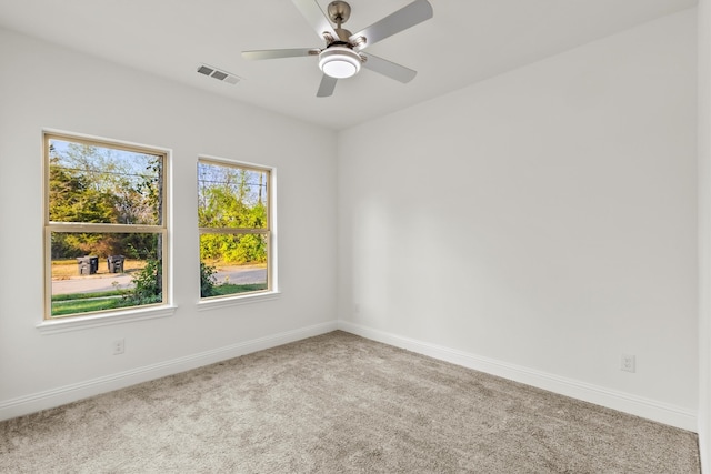 carpeted empty room featuring ceiling fan