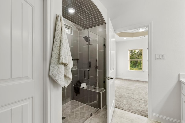 bathroom with vanity, walk in shower, and tile patterned flooring