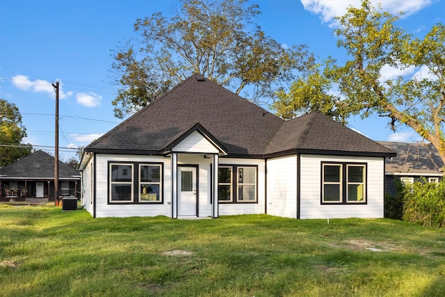 back of property featuring a lawn