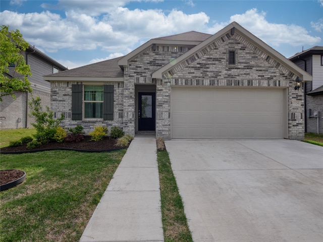 view of front facade with a front yard and a garage