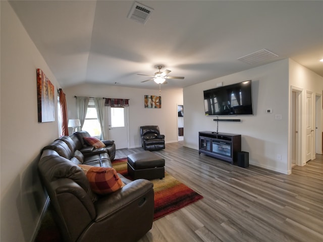 living room with hardwood / wood-style floors, ceiling fan, and lofted ceiling