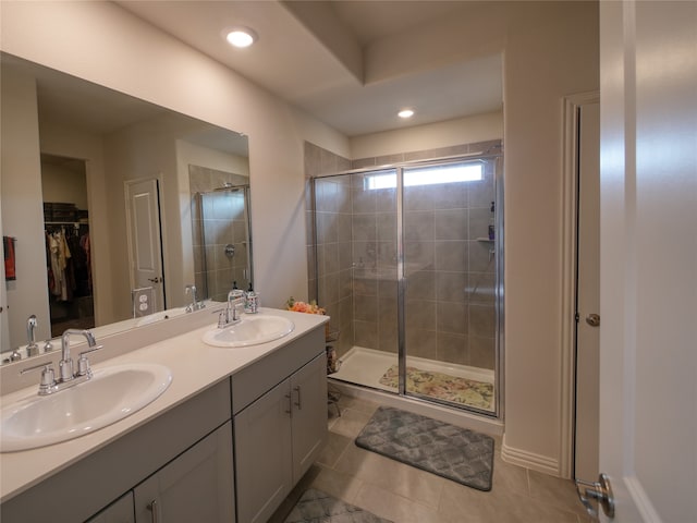 bathroom featuring vanity, tile patterned floors, and walk in shower