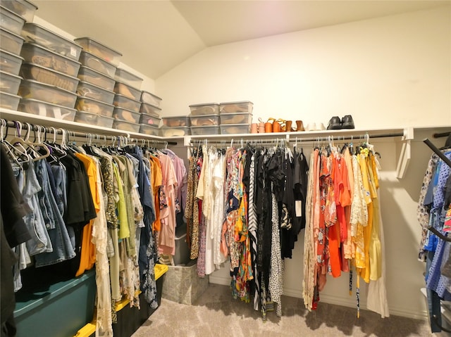 spacious closet featuring carpet floors and vaulted ceiling