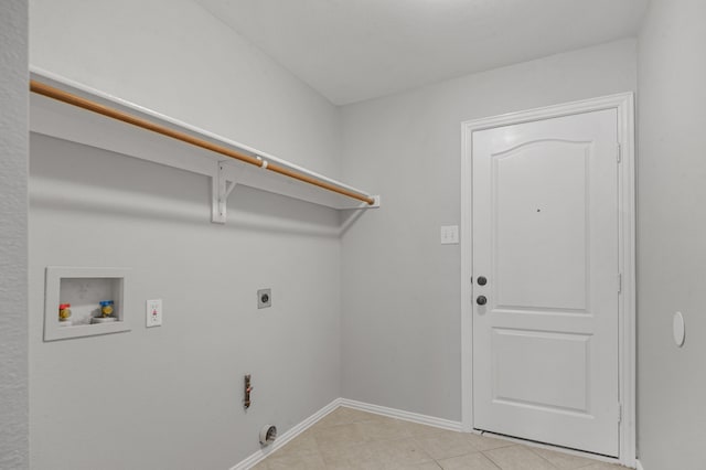 clothes washing area featuring hookup for a gas dryer, electric dryer hookup, hookup for a washing machine, and light tile patterned floors