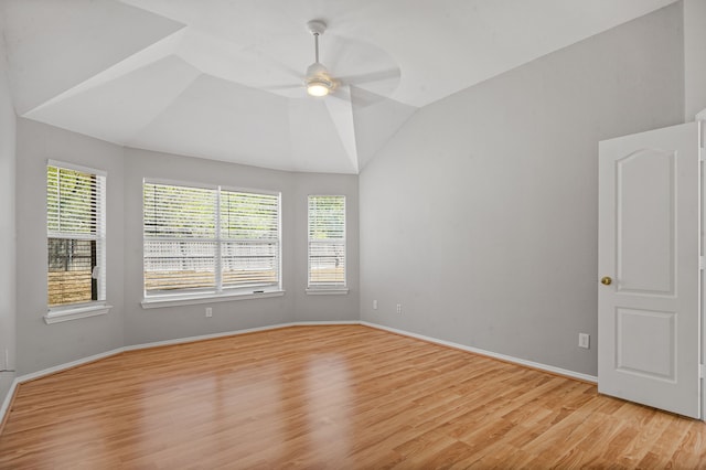 spare room with light hardwood / wood-style floors, lofted ceiling, ceiling fan, and a wealth of natural light