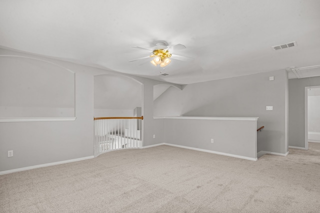 carpeted empty room with ceiling fan and lofted ceiling