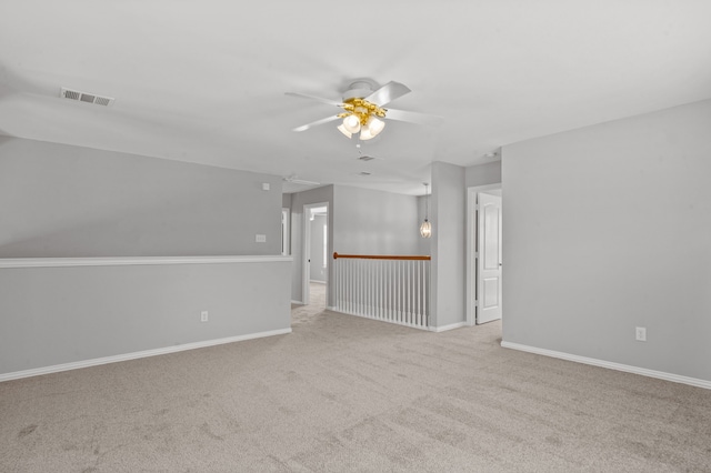 unfurnished room featuring light carpet and ceiling fan