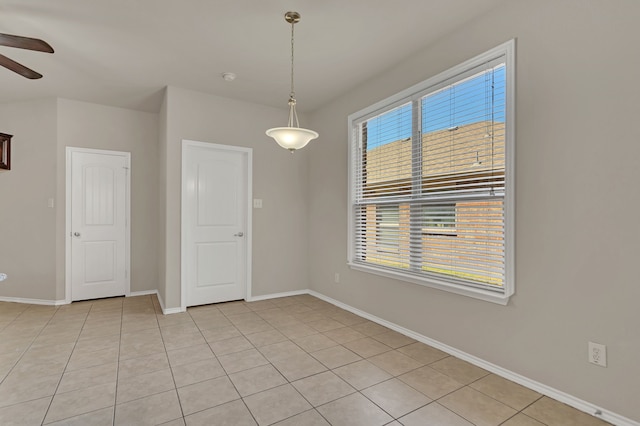 spare room featuring ceiling fan and light tile patterned floors