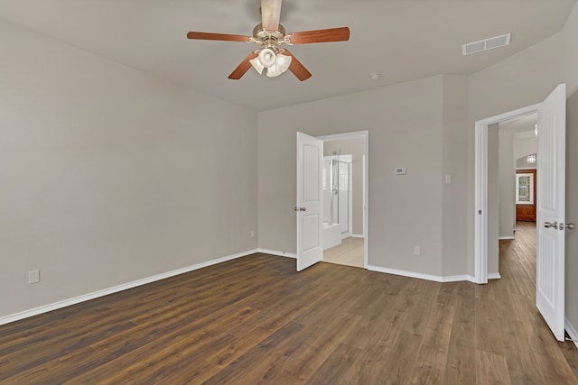 unfurnished bedroom with ceiling fan and dark wood-type flooring