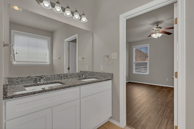 bathroom featuring wood-type flooring, ceiling fan, and vanity