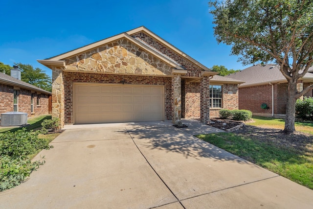 view of front of property with central AC unit and a garage