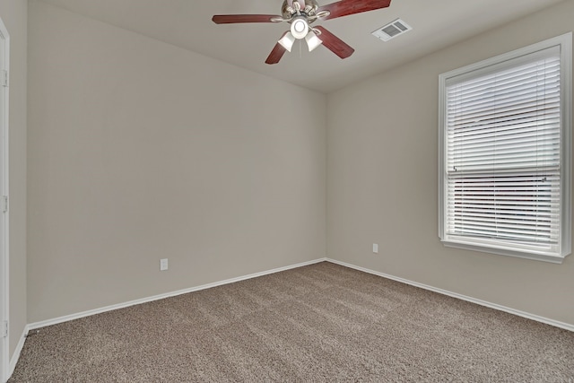 carpeted spare room featuring ceiling fan