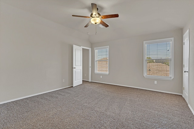 carpeted empty room with ceiling fan and plenty of natural light