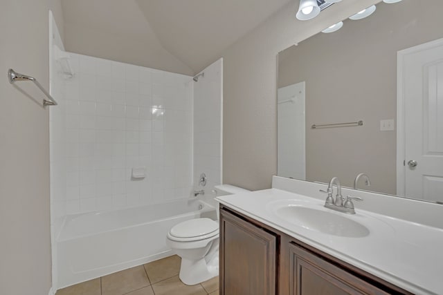 full bathroom featuring vanity, toilet, tiled shower / bath combo, tile patterned floors, and vaulted ceiling