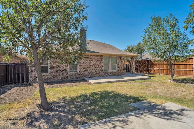 back of house featuring a lawn, a patio, and a wooden deck