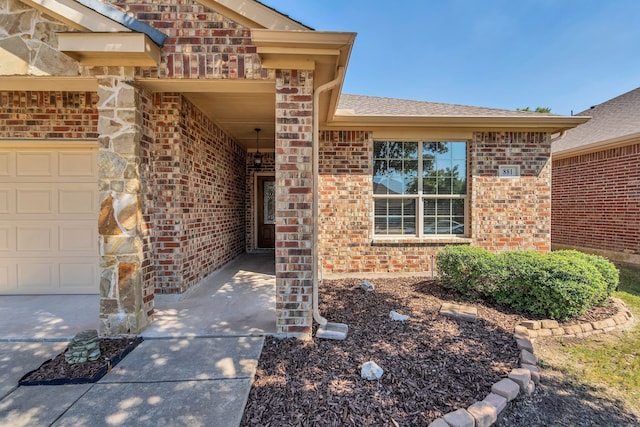 view of exterior entry with a garage