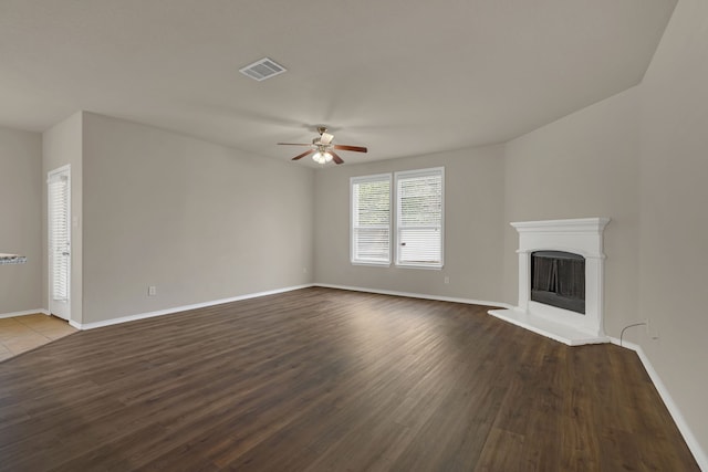 unfurnished living room with ceiling fan and dark hardwood / wood-style flooring