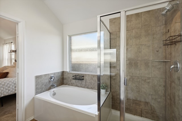 bathroom featuring separate shower and tub and vaulted ceiling