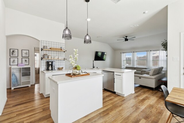 kitchen with white cabinetry, light hardwood / wood-style floors, pendant lighting, and stainless steel dishwasher