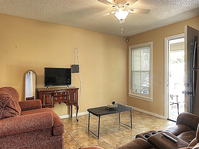 tiled living room with a textured ceiling and ceiling fan