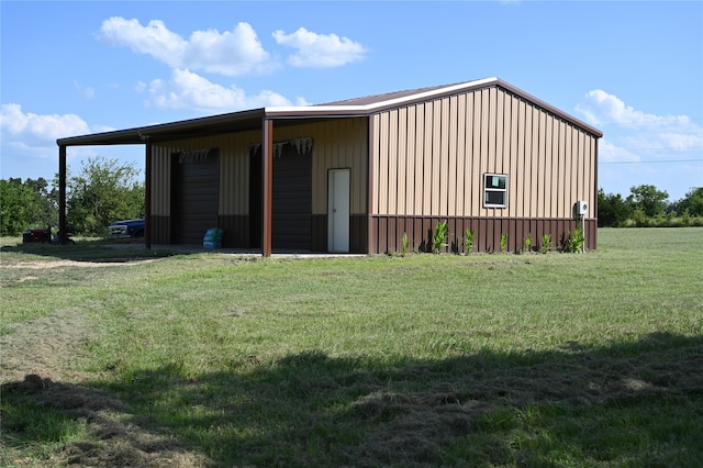 exterior space featuring an outdoor structure and a front lawn