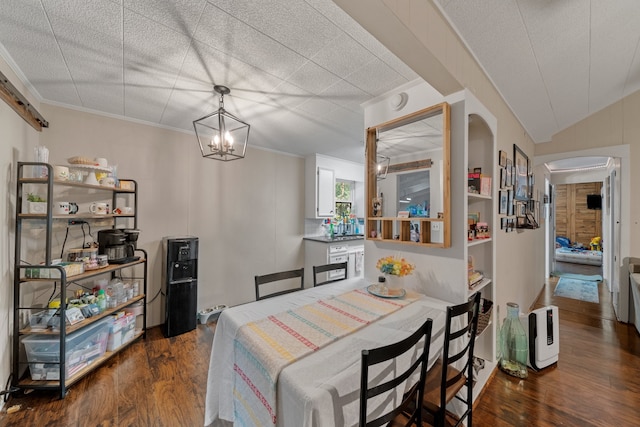 dining space featuring vaulted ceiling, a textured ceiling, ornamental molding, dark hardwood / wood-style floors, and a notable chandelier