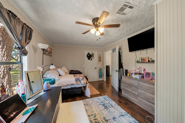 bedroom with ceiling fan, crown molding, and dark hardwood / wood-style flooring