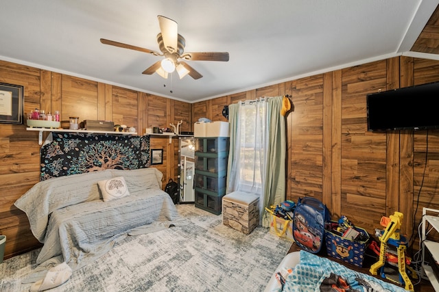 bedroom featuring wooden walls and ceiling fan