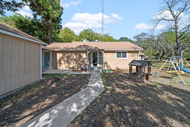 exterior space with a playground and a patio